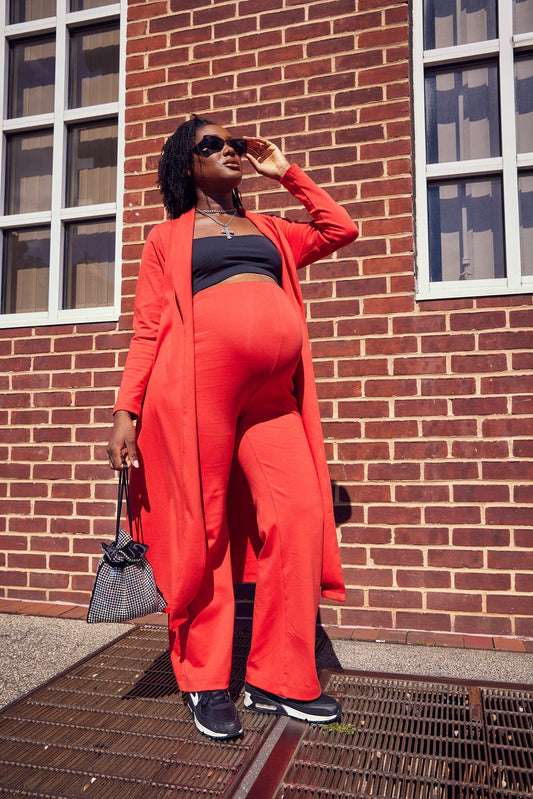 M Street model wearing the sunset orange Zahra Over Belly Maternity Pant 