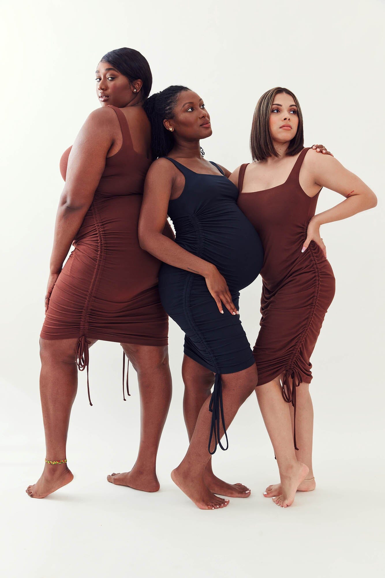 Three models showing off the variations of the Temi 3-in-1 Maternity Dress